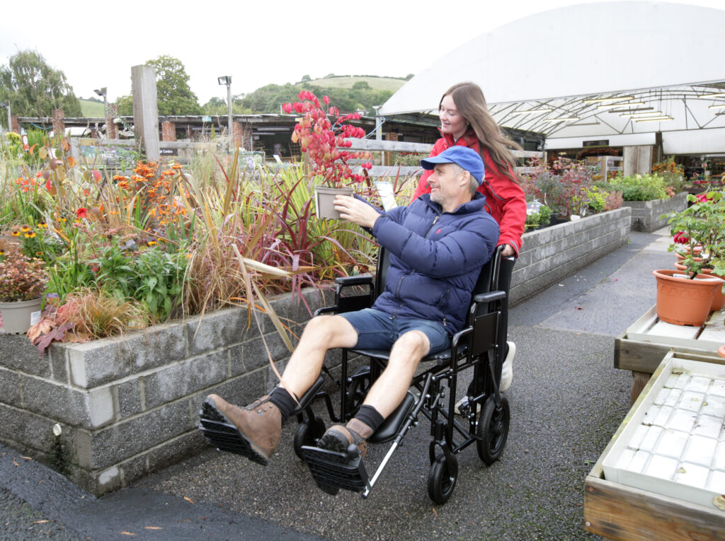 A Man enjoying Flower garden in Transit Wheelchair 